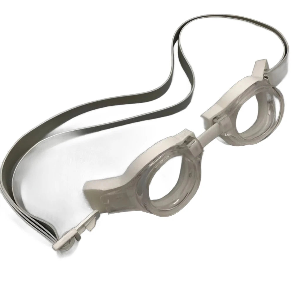 Clear Barracuda Medalist Swimming Goggles with white frames and a gray adjustable strap lying flat on a white surface, ideal for younger swimmers in training and competition. Clear Barracuda Medalist Swimming Goggles with white frames and a gray adjustable strap lying flat on a white surface, ideal for younger swimmers in training and competition.