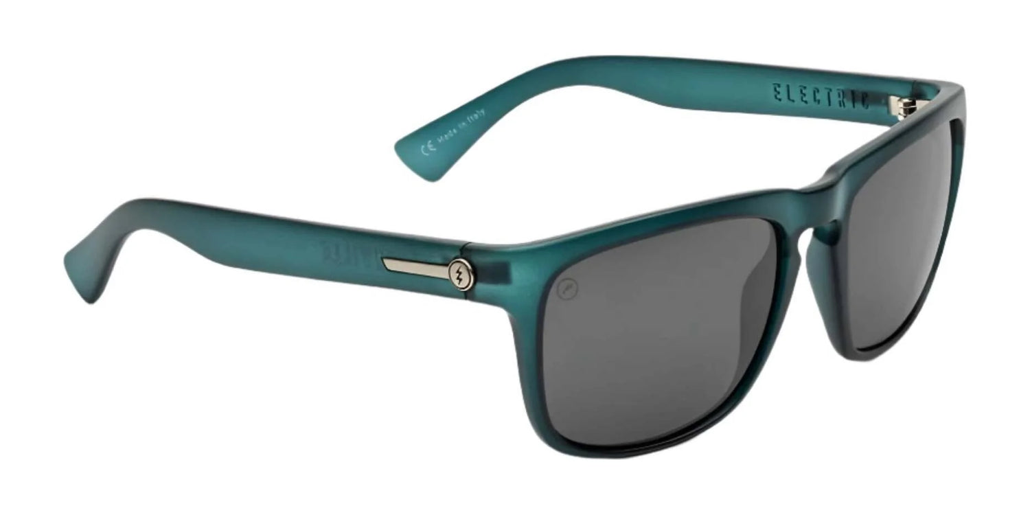 Electric Knoxville XL Sunglasses (Size 61) by Electric feature black lenses, metal hinge accents, and a sleek teal frame, offering superior sun protection and a lightweight fit for all-day comfort. Electric Knoxville XL Sunglasses (Size 61) by Electric feature black lenses, metal hinge accents, and a sleek teal frame, offering superior sun protection and a lightweight fit for all-day comfort.
