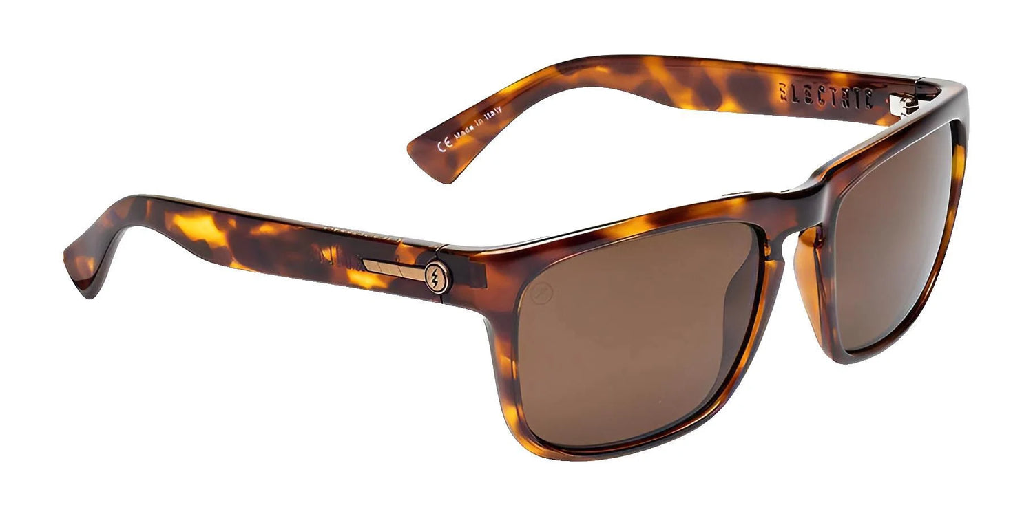 The Electric Knoxville XL Sunglasses (Size 61) by Electric feature a rectangular tortoiseshell frame with brown lenses, offering superior sun protection and a lightweight fit, shown from a slight angle. The Electric Knoxville XL Sunglasses (Size 61) by Electric feature a rectangular tortoiseshell frame with brown lenses, offering superior sun protection and a lightweight fit, shown from a slight angle.