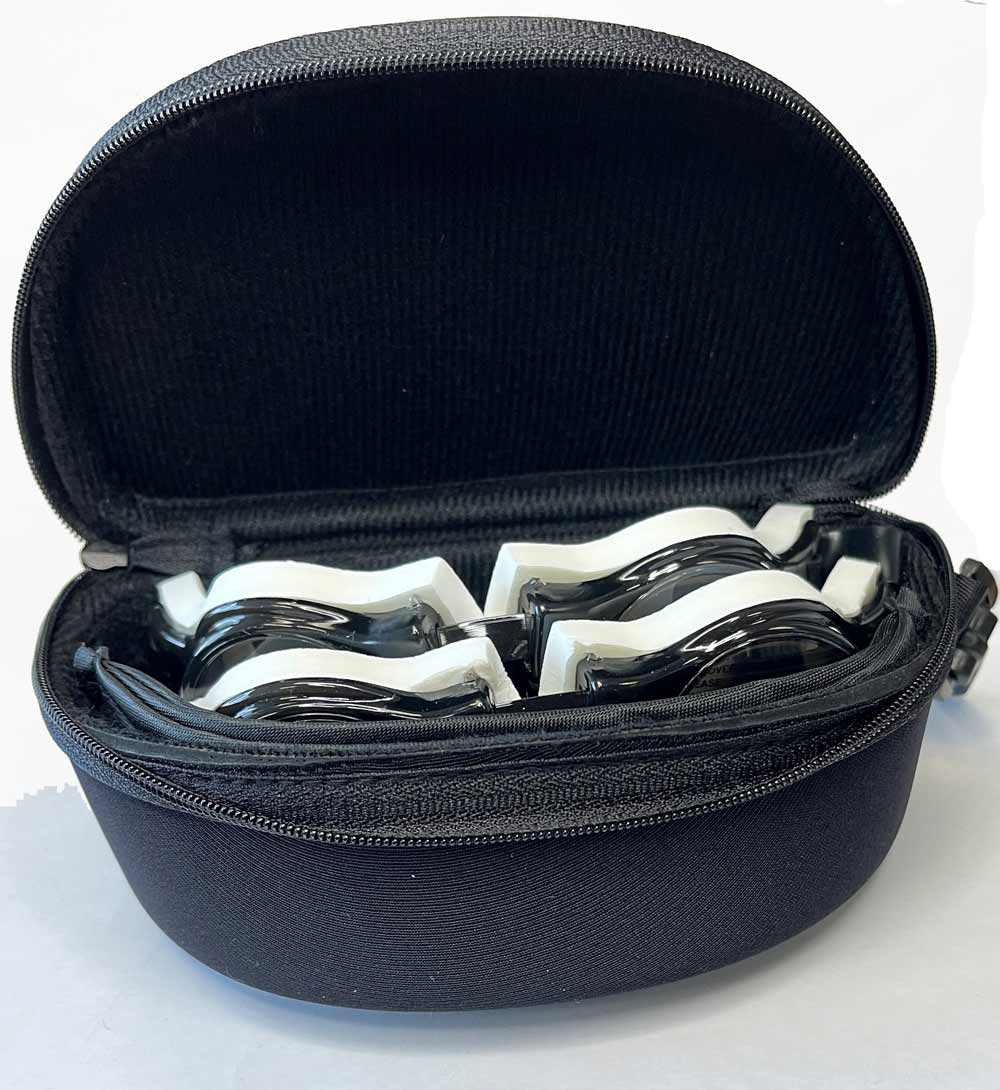 The Heavyglare Eyewear Heavyglare Hard Case is open to reveal four pairs of black and white protective goggles stored safely inside. The Heavyglare Eyewear Heavyglare Hard Case is open to reveal four pairs of black and white protective goggles stored safely inside.