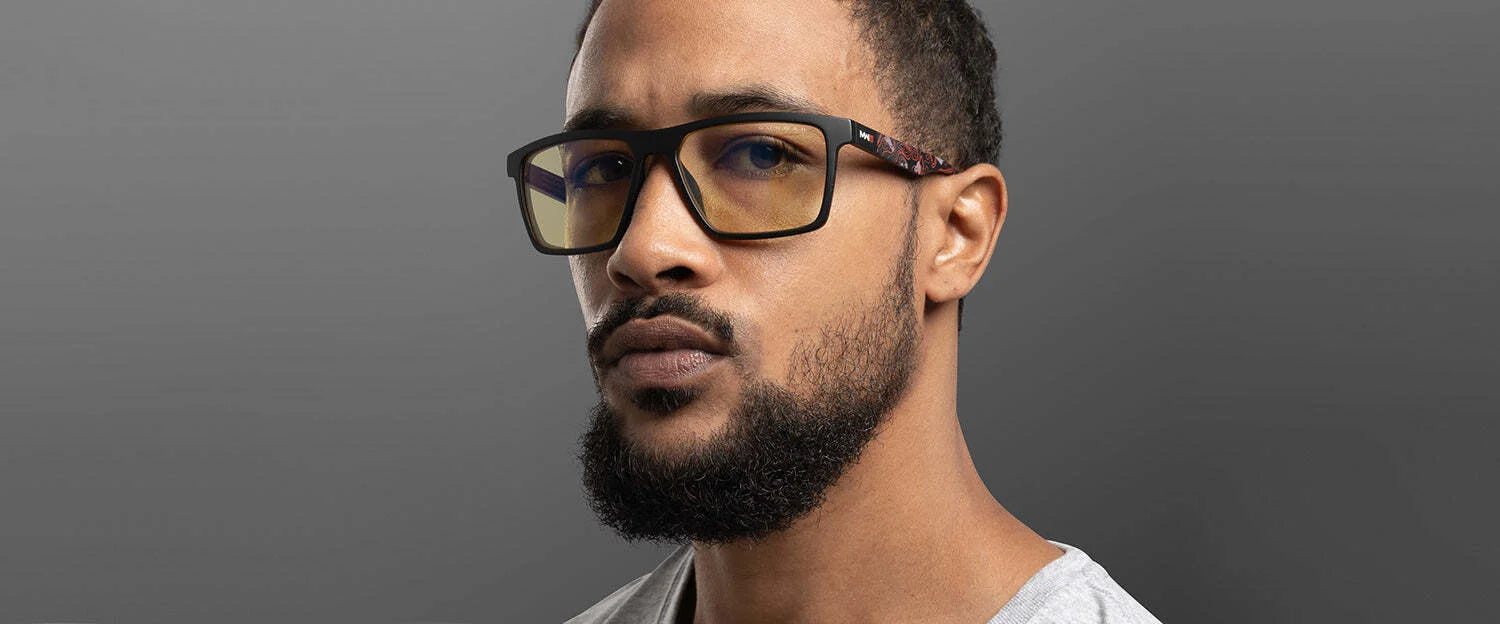 A man with short hair, a beard, and glasses featuring Gunnar technology for blue light blocking looks at the camera. He's wearing a gray shirt against a gray background. His glasses are the Gunnar Call of Duty Alpha Edition Computer Glasses | Size 57, perfect for marathon gaming sessions. A man with short hair, a beard, and glasses featuring Gunnar technology for blue light blocking looks at the camera. He's wearing a gray shirt against a gray background. His glasses are the Gunnar Call of Duty Alpha Edition Computer Glasses | Size 57, perfect for marathon gaming sessions.