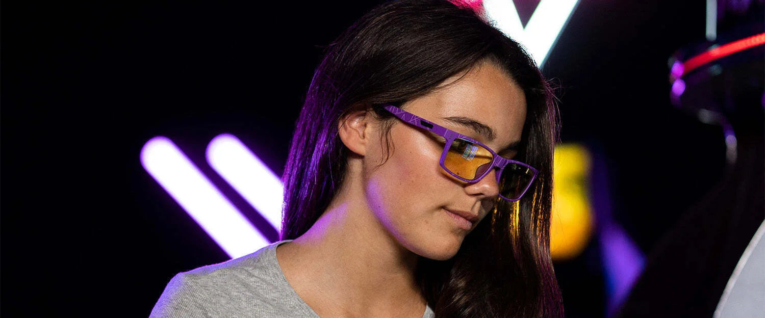 Wearing Gunnar Cruz Black Panther Edition Computer Glasses with a sturdy nylon frame, someone stands pensively against neon lights. Wearing Gunnar Cruz Black Panther Edition Computer Glasses with a sturdy nylon frame, someone stands pensively against neon lights.