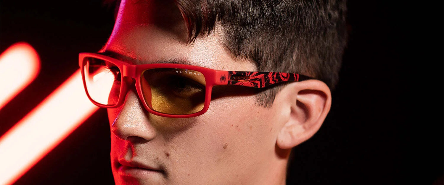 Under the glow of red lights, someone wears the Gunnar Enigma Spider-Man Miles Morales Edition Computer Glasses, featuring a solid nylon frame and yellow-tinted lenses. These stylish specs offer dependable blue light protection for any adventure. Under the glow of red lights, someone wears the Gunnar Enigma Spider-Man Miles Morales Edition Computer Glasses, featuring a solid nylon frame and yellow-tinted lenses. These stylish specs offer dependable blue light protection for any adventure.