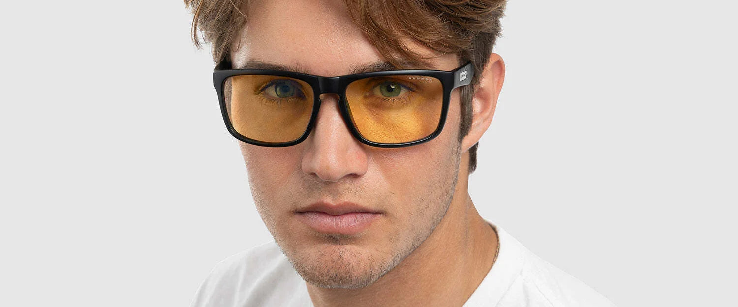 A man wears GUNNAR Intercept Computer Glasses in size 58, featuring yellow lenses for blue light protection, and looks directly at the camera against a plain background. A man wears GUNNAR Intercept Computer Glasses in size 58, featuring yellow lenses for blue light protection, and looks directly at the camera against a plain background.