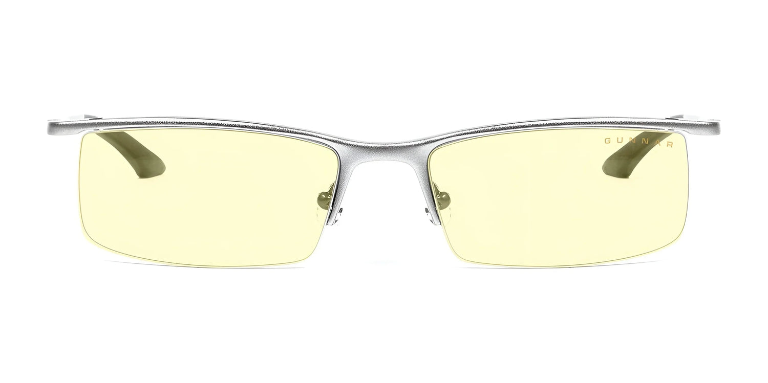 The Gunnar Emissary Computer Glasses, size 55, feature a silver frame and yellow-tinted blue light blocking lenses, shown from a front view. The Gunnar Emissary Computer Glasses, size 55, feature a silver frame and yellow-tinted blue light blocking lenses, shown from a front view.