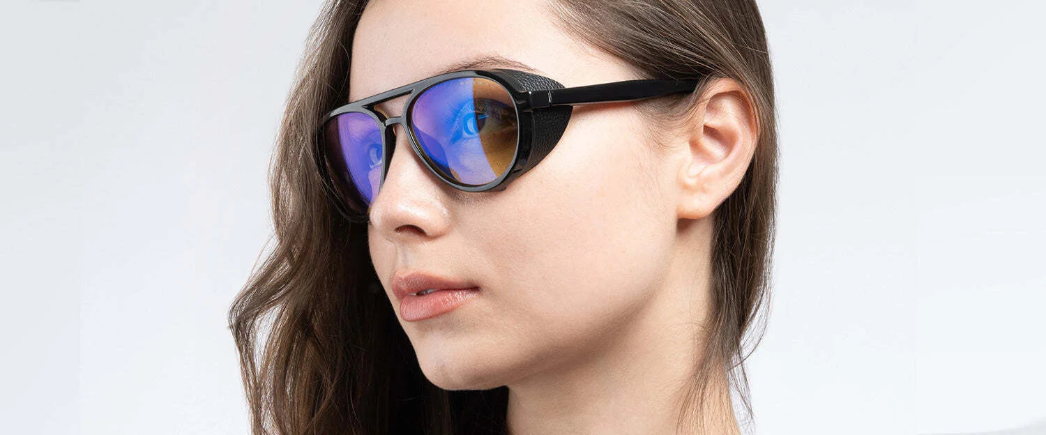 A woman wearing Gunnar Tallac Computer Glasses, featuring a stylish mountaineer-style black frame, looks to the side. A woman wearing Gunnar Tallac Computer Glasses, featuring a stylish mountaineer-style black frame, looks to the side.