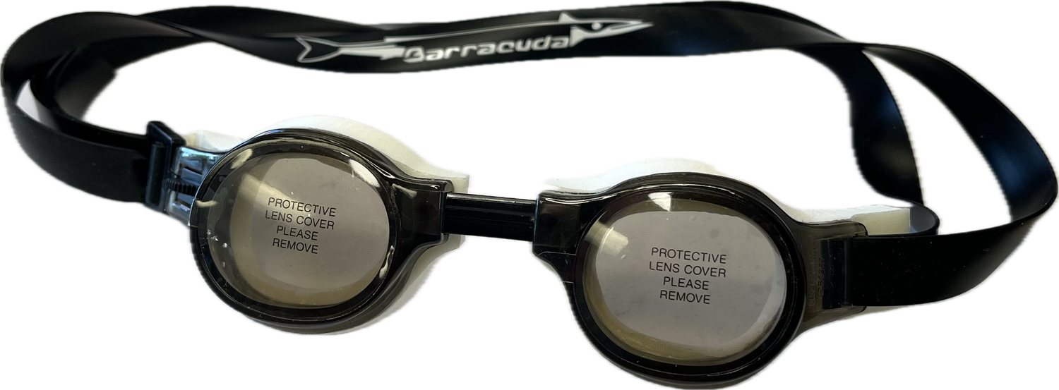 The Barracuda Medalist Swimming Goggles in smoke, ideal for both training and competition, come with protective lens covers labeled "PROTECTIVE LENS COVER PLEASE REMOVE," making them perfect for younger swimmers. The Barracuda Medalist Swimming Goggles in smoke, ideal for both training and competition, come with protective lens covers labeled "PROTECTIVE LENS COVER PLEASE REMOVE," making them perfect for younger swimmers.