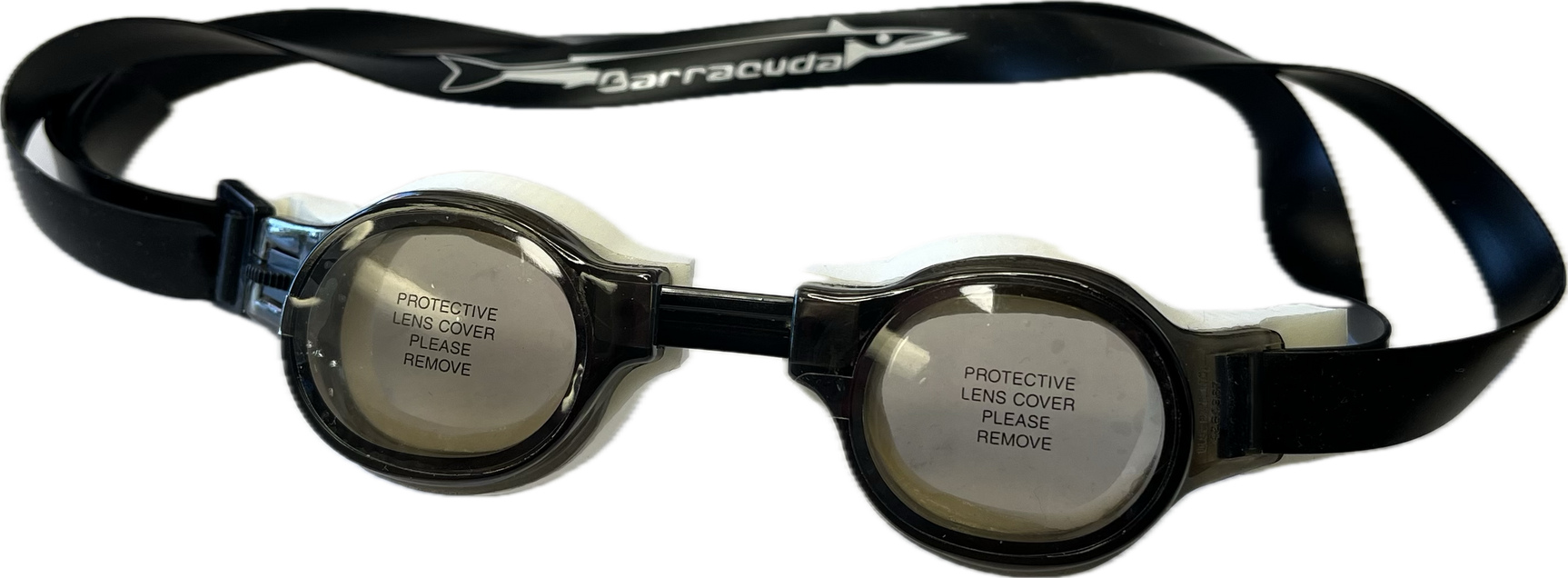 The Barracuda Medalist Swimming Goggles in smoke, ideal for both training and competition, come with protective lens covers labeled "PROTECTIVE LENS COVER PLEASE REMOVE," making them perfect for younger swimmers. The Barracuda Medalist Swimming Goggles in smoke, ideal for both training and competition, come with protective lens covers labeled "PROTECTIVE LENS COVER PLEASE REMOVE," making them perfect for younger swimmers.