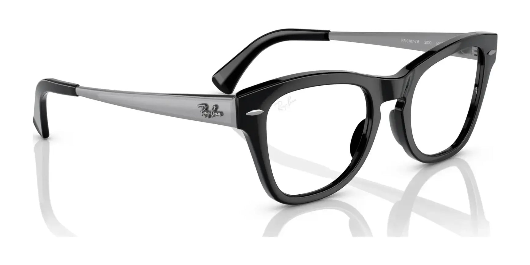 The Ray-Ban RX0707VM Eyeglasses feature an iconic design with black rectangular frames and silver temples, complete with the brand's logo on the side. Their durable construction is elegantly showcased as they rest on a reflective surface. The Ray-Ban RX0707VM Eyeglasses feature an iconic design with black rectangular frames and silver temples, complete with the brand's logo on the side. Their durable construction is elegantly showcased as they rest on a reflective surface.