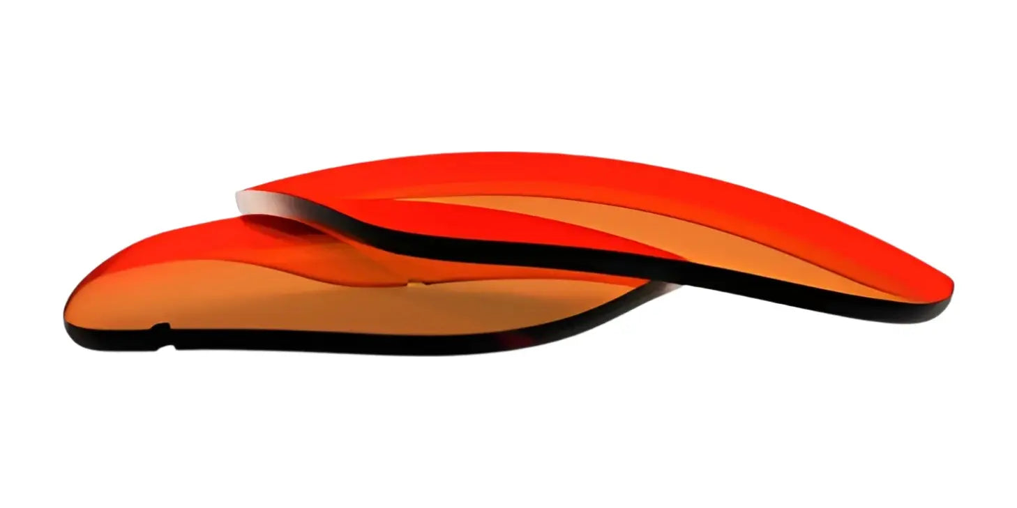 Two stacked, curved, translucent red-orange RE Ranger Classic Lenses from RE Ranger on a white background. Two stacked, curved, translucent red-orange RE Ranger Classic Lenses from RE Ranger on a white background.