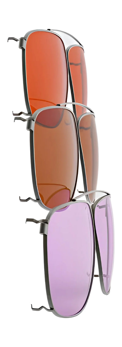 The RE Ranger Sporter Clip-On Lens Kit by RE Ranger offers four sets of clip-on lenses in various colors—orange, brown, red, and purple—neatly organized on a vertical stand, designed to elevate your shooting performance.