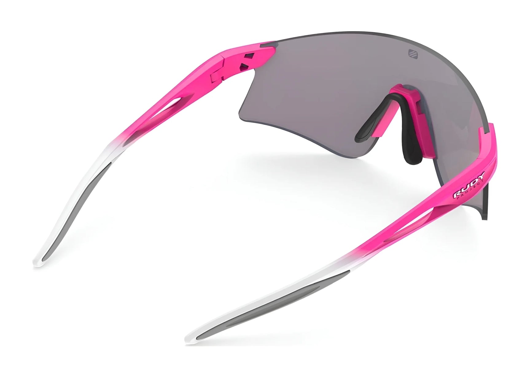 The Rudy Project Astral Sunglasses (Size 147) feature a single grey lens, pink and white frame, black ear and nose pads, and built-in UV protection. The Rudy Project Astral Sunglasses (Size 147) feature a single grey lens, pink and white frame, black ear and nose pads, and built-in UV protection.