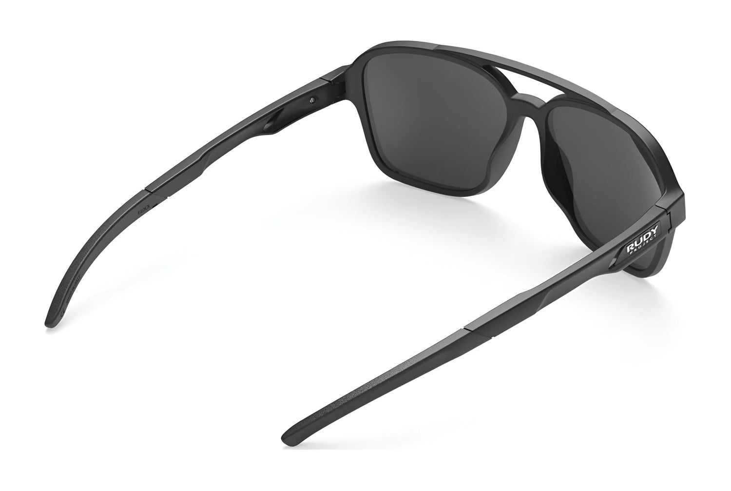 The Rudy Project Croze Sunglasses | Size 57 by Rudy Project feature black rectangular lenses in a slightly folded, angled rear view, combining stylish design with UV protection for your eyes. The Rudy Project Croze Sunglasses | Size 57 by Rudy Project feature black rectangular lenses in a slightly folded, angled rear view, combining stylish design with UV protection for your eyes.