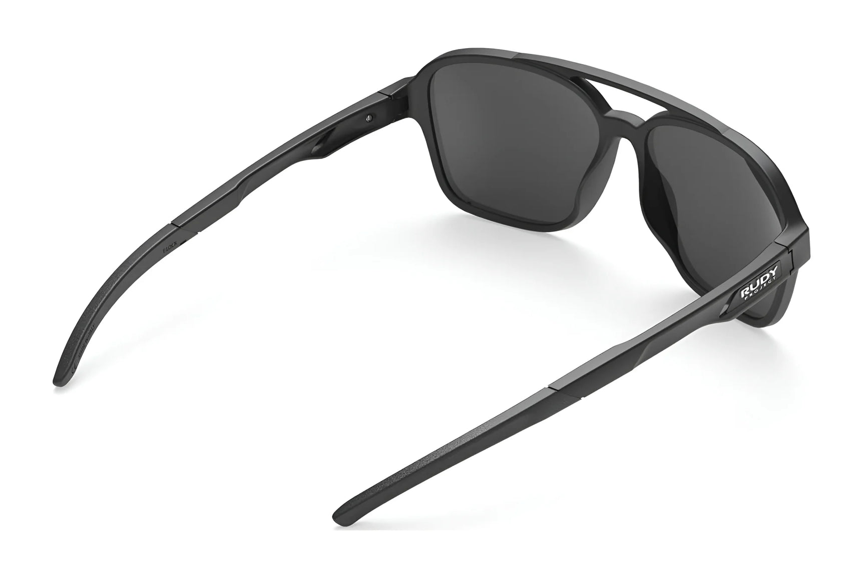 The Rudy Project Croze Sunglasses | Size 57 by Rudy Project feature black rectangular lenses in a slightly folded, angled rear view, combining stylish design with UV protection for your eyes. The Rudy Project Croze Sunglasses | Size 57 by Rudy Project feature black rectangular lenses in a slightly folded, angled rear view, combining stylish design with UV protection for your eyes.