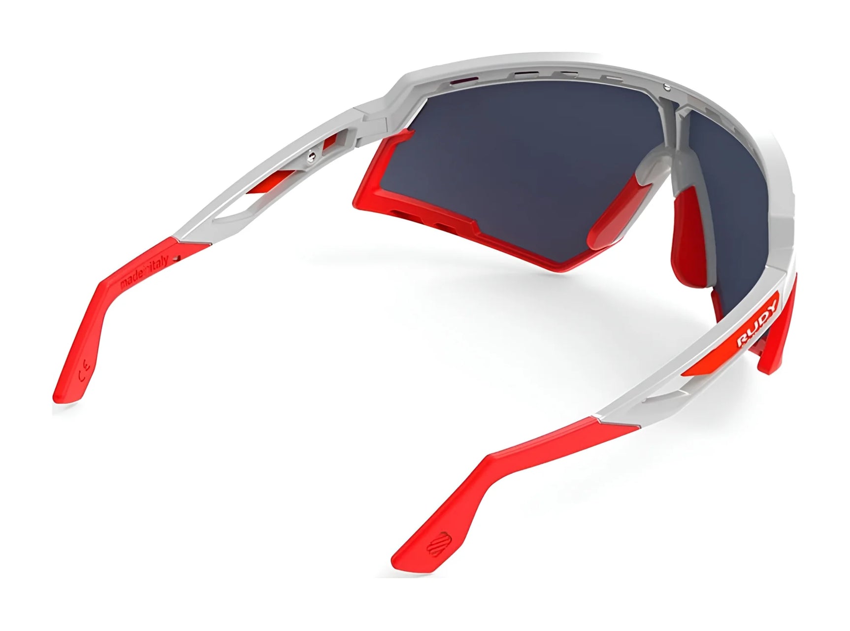 Rudy Project Defender Sunglasses | Size 141 by Rudy Project feature a white and red frame with dark tinted, interchangeable lenses, shown from a rear angle. Rudy Project Defender Sunglasses | Size 141 by Rudy Project feature a white and red frame with dark tinted, interchangeable lenses, shown from a rear angle.