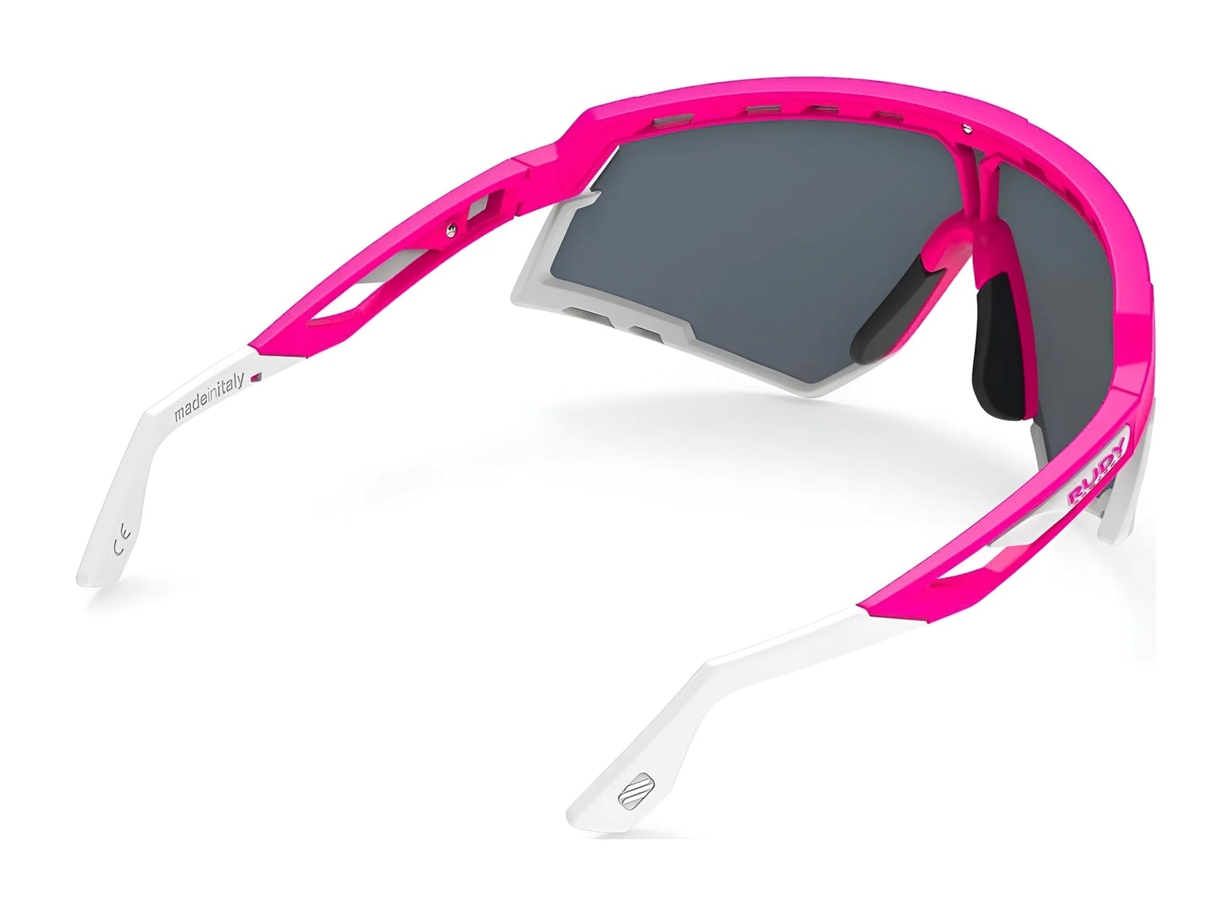 Rudy Project Defender Sunglasses | Size 141: Sporty pink and white frame with dark lenses, shown from an angle; compatible with interchangeable lenses for versatile style. Rudy Project Defender Sunglasses | Size 141: Sporty pink and white frame with dark lenses, shown from an angle; compatible with interchangeable lenses for versatile style.