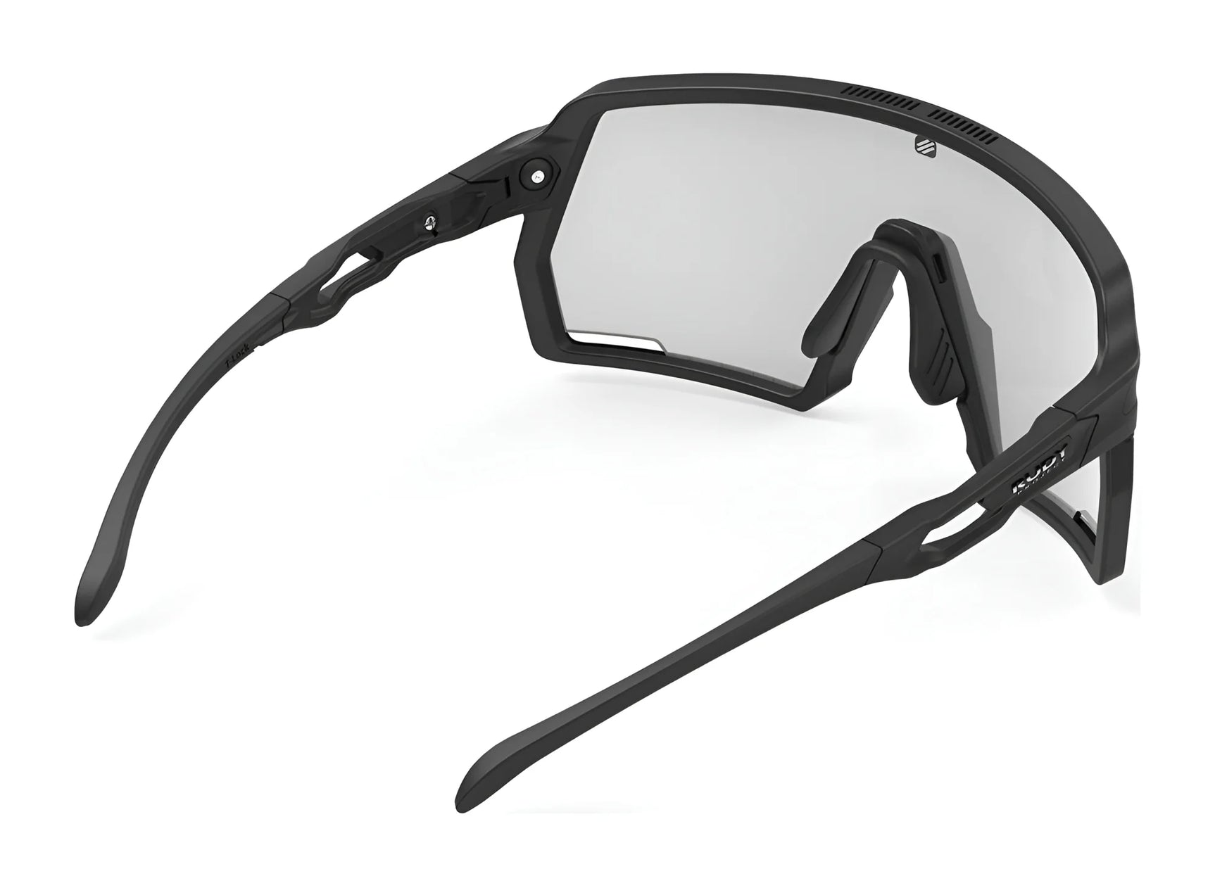 The Rudy Project Kelion Sunglasses in size 144 feature an angular, matte black wraparound frame and clear lenses that provide UV protection—ideal for active lifestyles. The Rudy Project Kelion Sunglasses in size 144 feature an angular, matte black wraparound frame and clear lenses that provide UV protection—ideal for active lifestyles.