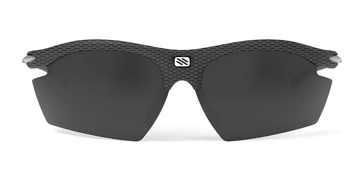 Rudy Project Rydon Sunglasses by Rudy Project feature dark, semi-rimless lenses, a textured carbon-fiber-look frame, and adjustable anti-slip nosepads for a secure fit, shown against a white background. Rudy Project Rydon Sunglasses by Rudy Project feature dark, semi-rimless lenses, a textured carbon-fiber-look frame, and adjustable anti-slip nosepads for a secure fit, shown against a white background.