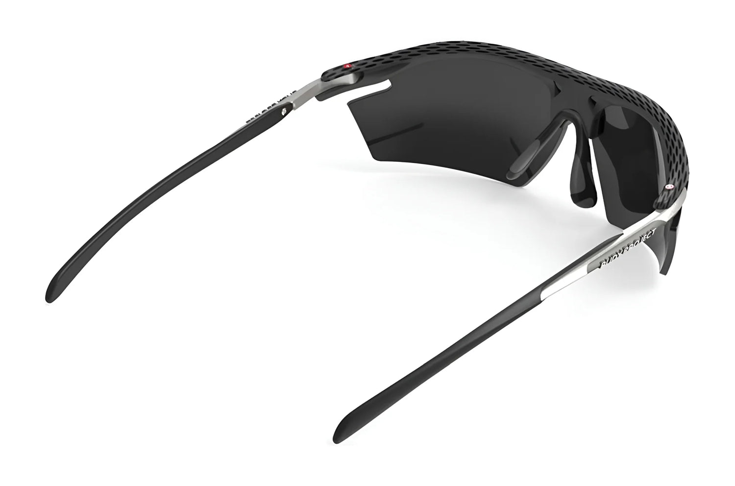 The Rudy Project Rydon Sunglasses by Rudy Project feature a black and silver curved frame, dark lenses, and adjustable anti-slip nosepads, shown from a rear angle. The Rudy Project Rydon Sunglasses by Rudy Project feature a black and silver curved frame, dark lenses, and adjustable anti-slip nosepads, shown from a rear angle.