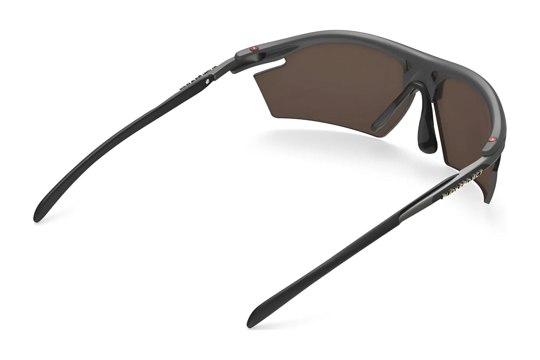 Rudy Project Rydon Sunglasses by Rudy Project with brown-tinted lenses and adjustable anti-slip nosepads, viewed from the back at an angle on a white background. Rudy Project Rydon Sunglasses by Rudy Project with brown-tinted lenses and adjustable anti-slip nosepads, viewed from the back at an angle on a white background.