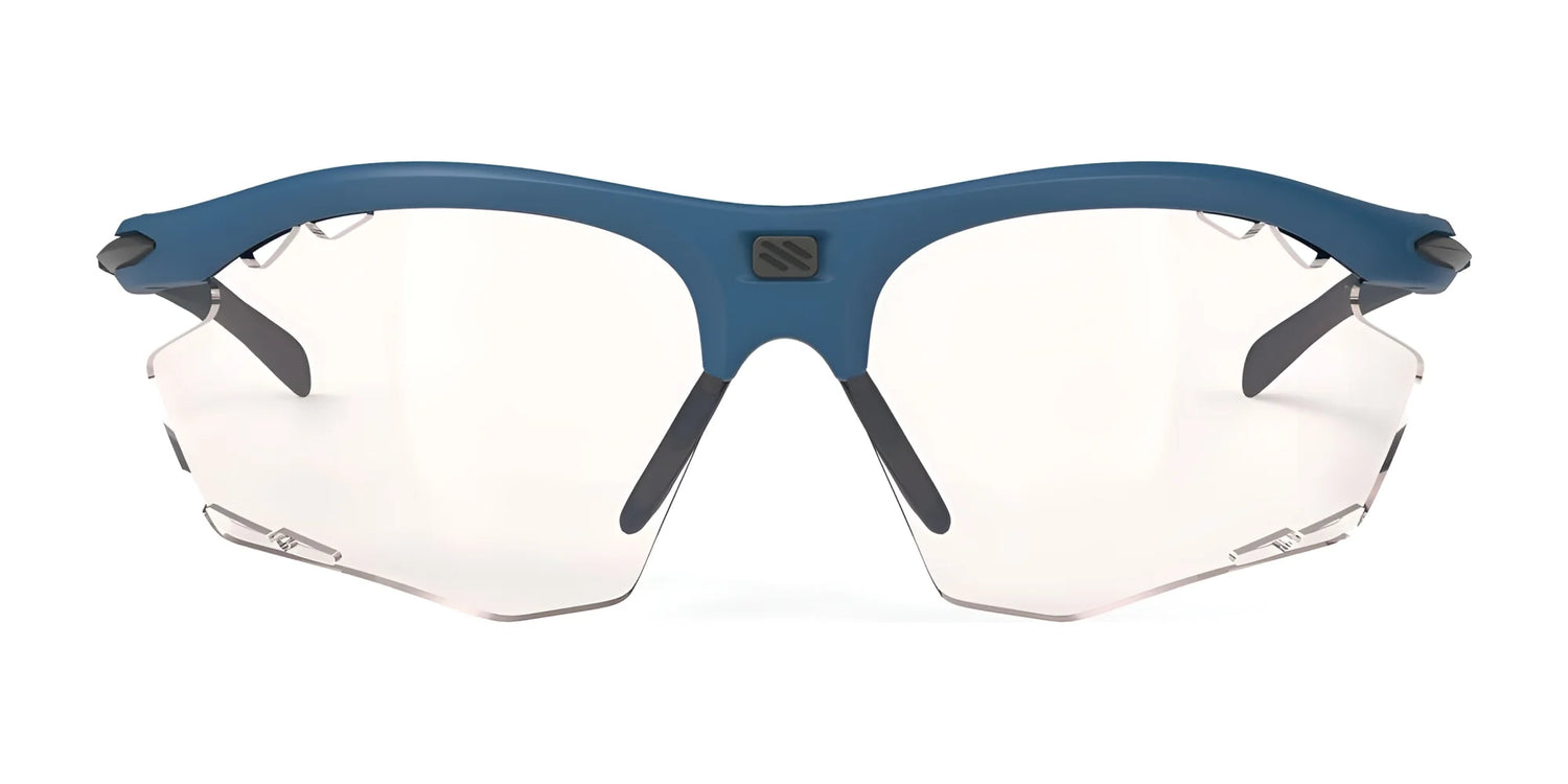 The Rudy Project Rydon Sunglasses by Rudy Project are blue-framed, rimless sports sunglasses with clear lenses, shown from the front and featuring adjustable anti-slip nosepads for a secure fit. The Rudy Project Rydon Sunglasses by Rudy Project are blue-framed, rimless sports sunglasses with clear lenses, shown from the front and featuring adjustable anti-slip nosepads for a secure fit.