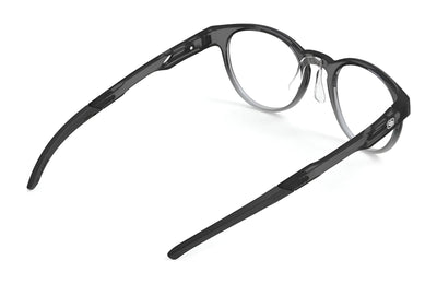 The Rudy Project Step 02 Eyeglasses (Size 48) by Rudy Project are black, round frames with clear nose pads and adjustable temple tips, shown from angled side and rear views on a white background.