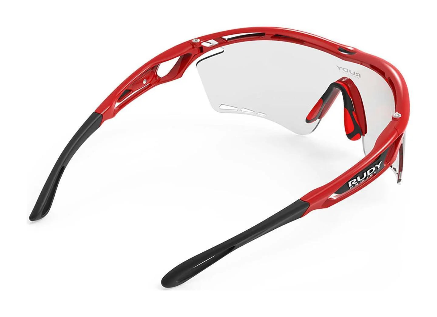 Rudy Project Tralyx Sunglasses in red and black with clear ImpactX-2 lenses, a wraparound frame, and PowerFlow™, shown from the back. Rudy Project Tralyx Sunglasses in red and black with clear ImpactX-2 lenses, a wraparound frame, and PowerFlow™, shown from the back.