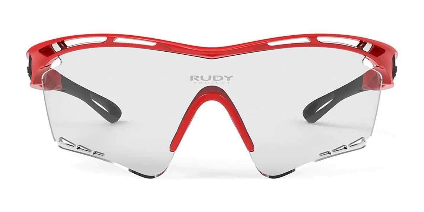 Rudy Project Tralyx Sunglasses in red and black with clear ImpactX-2 lenses, shown from the front and featuring Rudy Project branding. Rudy Project Tralyx Sunglasses in red and black with clear ImpactX-2 lenses, shown from the front and featuring Rudy Project branding.