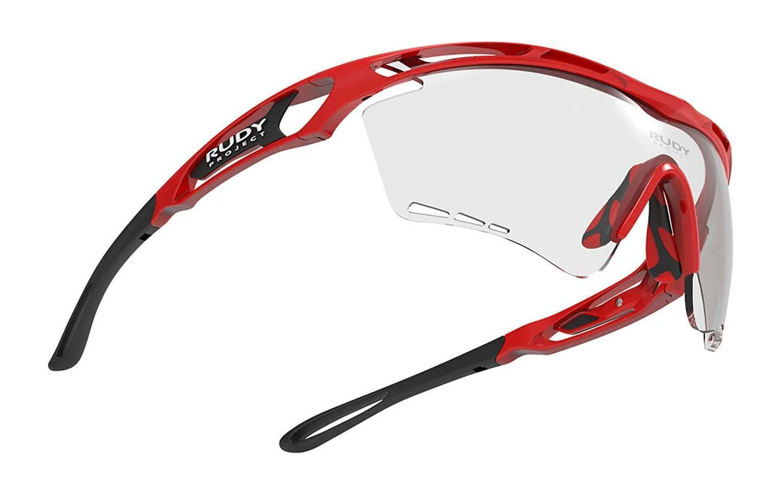 Rudy Project Tralyx Sunglasses feature a red and black frame, clear ImpactX-2 lenses, and a sleek PowerFlow™ aerodynamic design. Rudy Project Tralyx Sunglasses feature a red and black frame, clear ImpactX-2 lenses, and a sleek PowerFlow™ aerodynamic design.