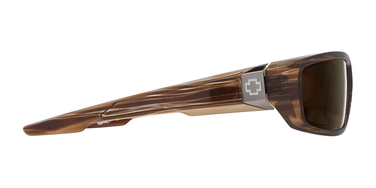 Side view of SPY DIRTY Mo tortoiseshell sunglasses, size 61, with wide arms and a silver cross emblem near the hinge, enhanced with Trident polarization for optimal clarity. Side view of SPY DIRTY Mo tortoiseshell sunglasses, size 61, with wide arms and a silver cross emblem near the hinge, enhanced with Trident polarization for optimal clarity.