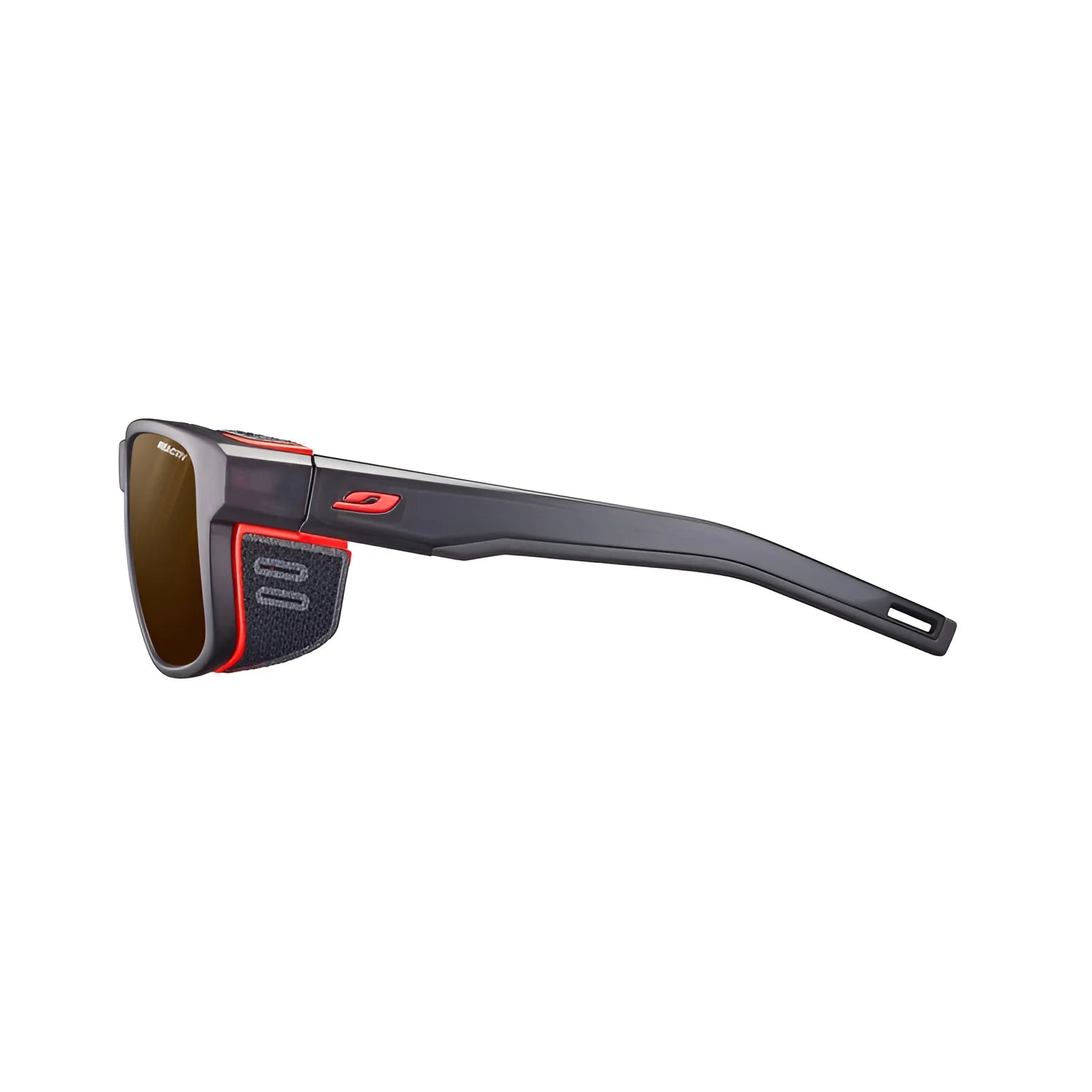 Side view of Julbo's black Shield sunglasses in size 59, showcasing the M design with red accents, dark lenses, and a Grip Nose for enhanced comfort. Side view of Julbo's black Shield sunglasses in size 59, showcasing the M design with red accents, dark lenses, and a Grip Nose for enhanced comfort.