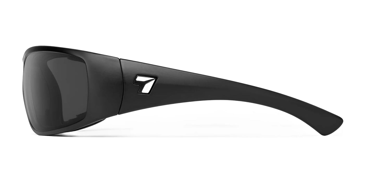 A side view of the black 7eye Taku Plus Sunglasses in size 67 showcases a small cutout logo on the temple. These sunglasses are fitted with an AirShield Wind Blocking Foam Eyecup for added comfort and provide 100% UVA and UVB protection.