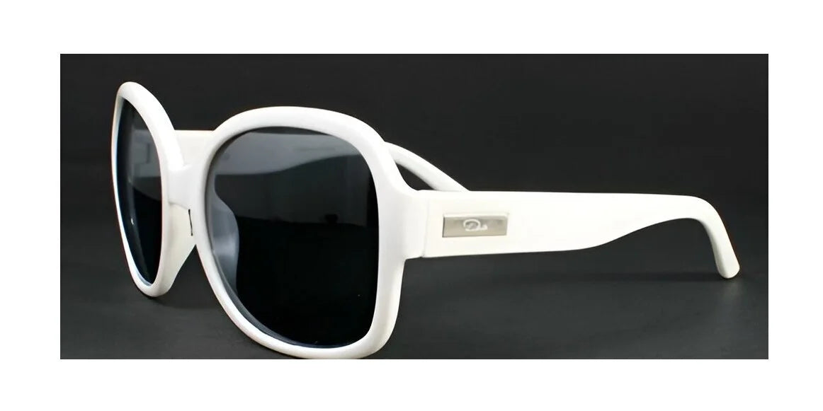 The DEA Eyewear DESIRE Sunglasses feature white oversized frames paired with dark polarized lenses, beautifully contrasted against a sleek black background.