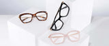 On white stepped platforms are three pairs of Gunnar Anna Computer Glasses in tortoiseshell, black, and pink. Featuring Gunnar lens technology, these stylish cat-eye frames offer blue light blocking for exceptional eye protection.