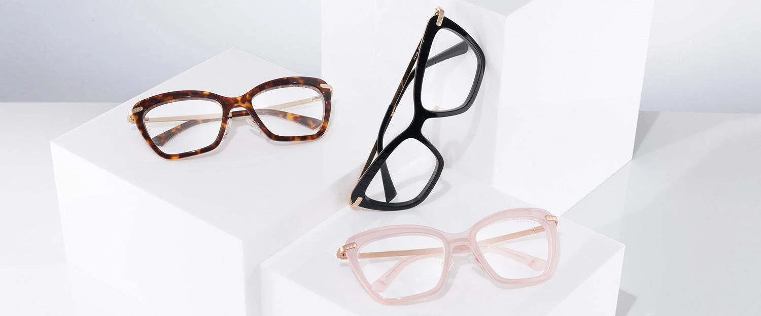 Three pairs of Gunnar Anna Computer Glasses (Size 54) on white platforms: tortoiseshell, black, and translucent pink cat-eye frames featuring GUNNAR lens technology for superior blue light blocking and stylish protection.