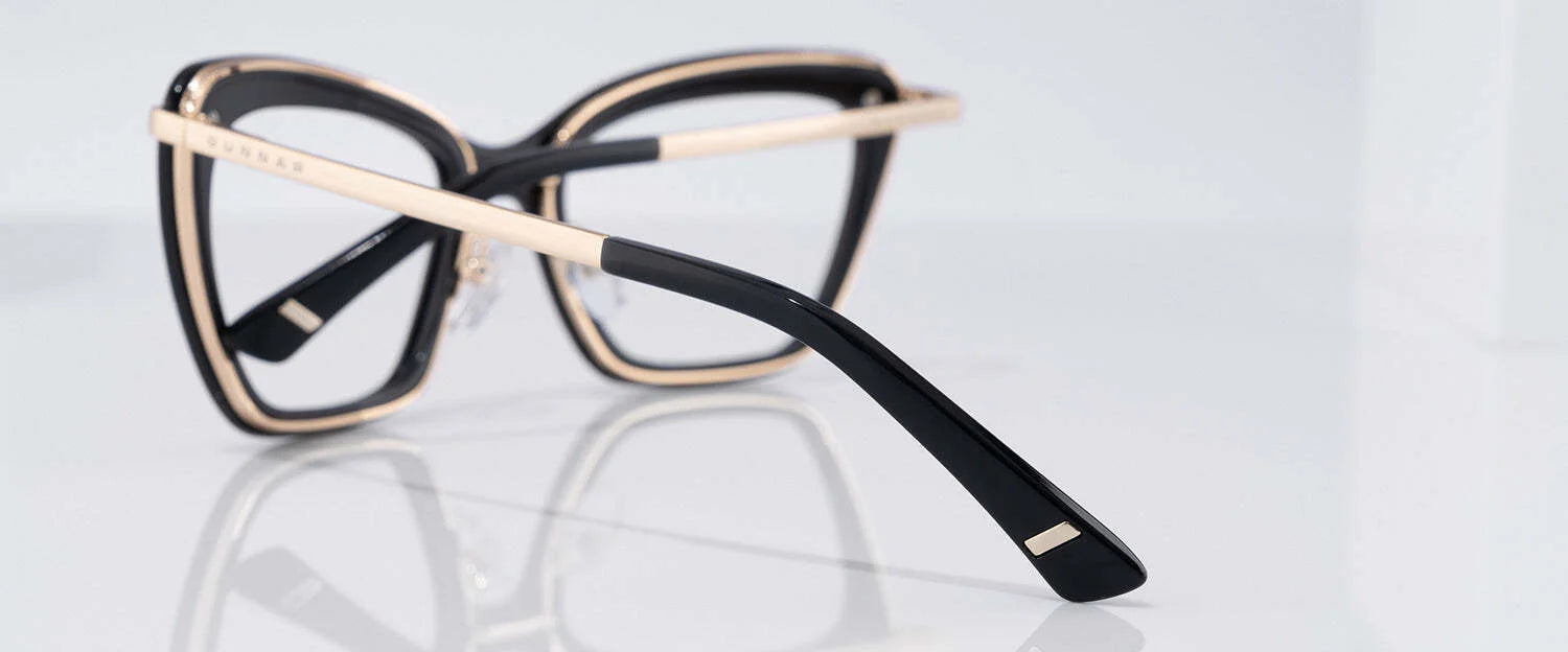 Reflective black and gold-frame Gunnar Anna Computer Glasses with thick rims, offering optimal blue light blocking through GUNNAR lens technology. Size 54.