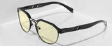 The Gunnar Campbell Computer Glasses (Size 52) feature a sleek black frame with yellow-tinted lenses, offering stylish protection on a reflective white surface thanks to their blue light-blocking technology.