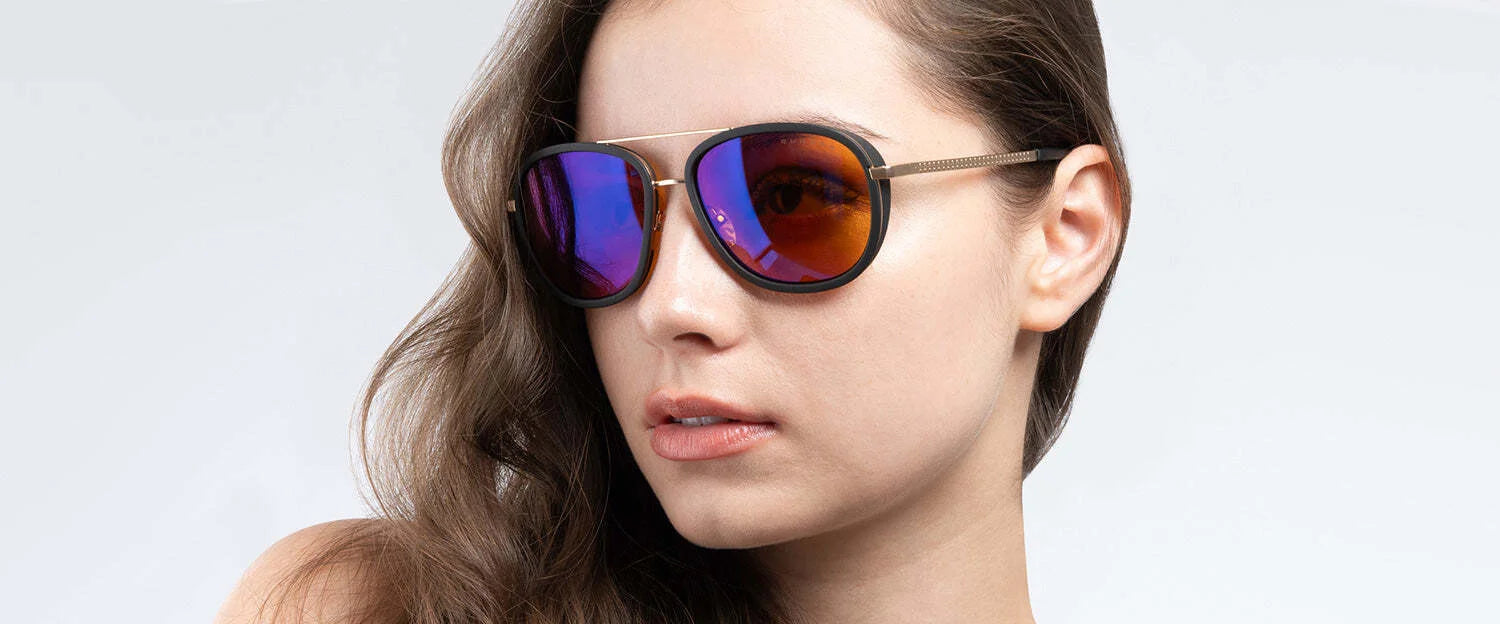 A person wearing Gunnar Dume Computer Glasses | Size 57 with stainless steel aviator frames and mirrored lenses, and having brown hair, maintains a neutral expression against a plain background.