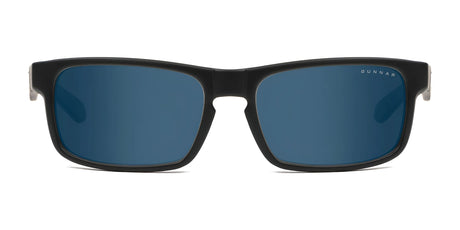 The Gunnar Enigma Sunglasses | Size 58 from Gunnar feature black frames with blue-tinted, wide-format lenses that block UVA and UVB rays, combining style and protection. Photographed frontally on a white background.