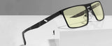 The Gunnar Fremont Computer Glasses, size 59, with sleek black rims and yellow-tinted lenses, elegantly rest on a white surface. Designed for blue light blocking, they provide comfort and style during extended screen time.