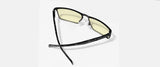 The Gunnar Fremont Computer Glasses | Size 59 boast black-rimmed, yellow-tinted lenses designed to block blue light. Their sleek mix of stainless steel and acetate adds a modern touch on a light backdrop.