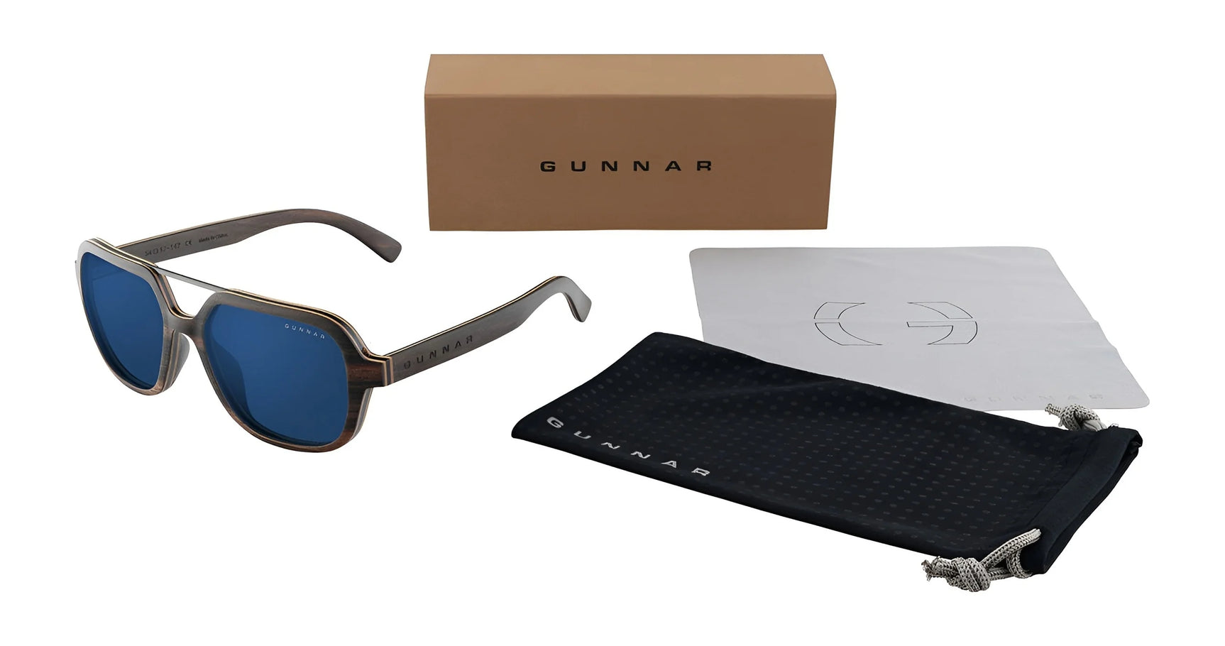 Aviator-style Humboldt sunglasses from Gunnar feature blue lenses, chic brown frames, and blue light blocking technology. They include a sleek black pouch, cleaning cloth, and a distinctive brown Gunnar box.