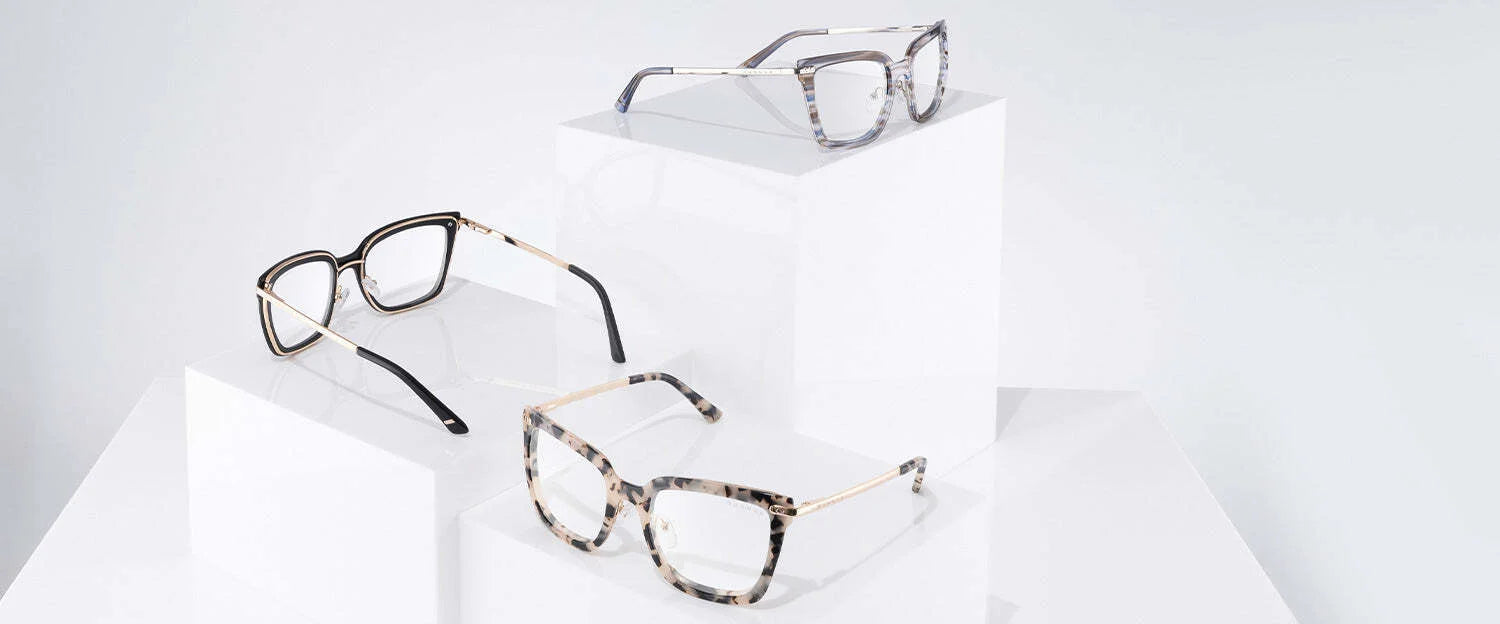 Three pairs of Gunnar Kaia Computer Glasses, with patterned frames and contemporary square designs, are displayed elegantly on white pedestals against a light backdrop.