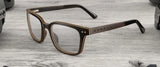 From the AROBR Collection, Gunnar Muir Computer Glasses feature a stylish rectangular frame in sustainably harvested ebony wood, beautifully presented on a wooden surface.