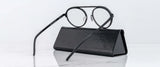 Gunnar Pacifica Computer Glasses in black, featuring a minimalist design, are displayed resting on a sleek rectangular case against a white background.