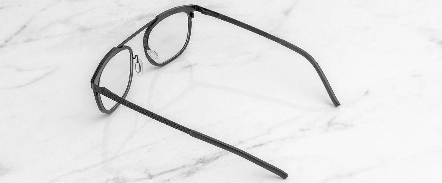 Gunnar Pismo Computer Glasses, in classic black with thin frames, rest elegantly on a white marble surface, providing stylish comfort and potential blue light protection.