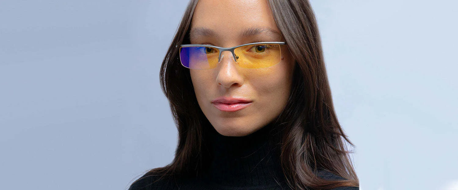 Person wearing Gunnar Emissary Computer Glasses, featuring blue light blocking and anti-reflective lenses, teamed with a black turtleneck against a light gray background.