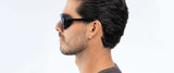 A profile of a person with dark hair wearing Gunnar Tallac Sunglasses, Size 57, set against a light background.