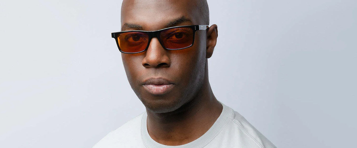 A person wearing Gunnar Vertex Computer Glasses | Size 55 and a white shirt looks directly at the camera against a plain background.