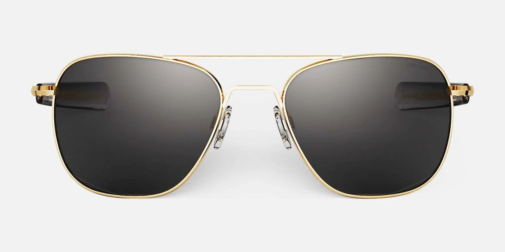 The Randolph AVIATOR sunglasses in size 58 showcase gold frames with dark lenses, providing excellent protection. Handcrafted in the USA, these sunglasses embody a timeless style, set against a white background.